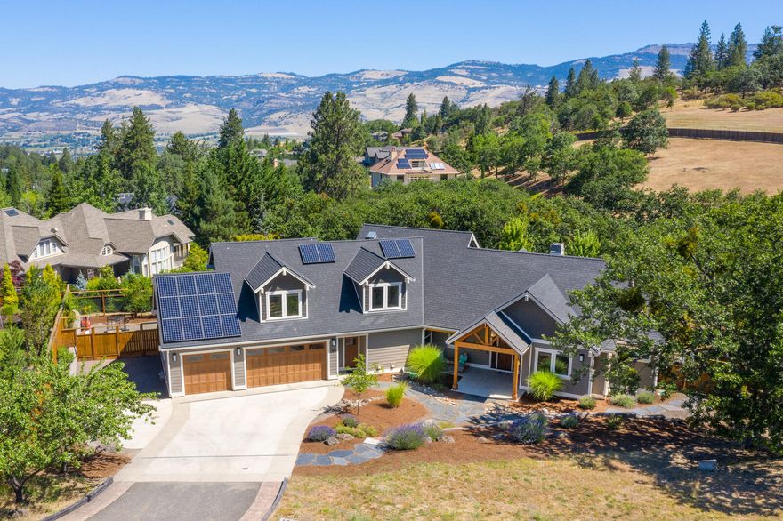 Beautiful custom home on half of an acre lot in a neighborhood of high-end homes. Picturesque views of the surrounding mountains and lots of natural light. Home has four bedrooms and two and half bathrooms with approx. 3200 SF, versatile and open floor plan. Living room has a tall open beam ceiling, wall of windows and a gas fireplace w/built-in cabinetry. Well laid out chef's kitchen has Thermador PRO appliances, large walk-in pantry and a butcher block center island overlooking the dining area. Main level master bedroom suite has a spa-like bathroom w/soaking tub, dual sinks, shower and walk-in closet. Also, on the main level is a bedroom (or office), half bath and laundry. Upstairs you will find two additional bedrooms with a shared bathroom and a spacious family room or could be 5th bedroom. The grounds have a nice mixture of hardscape, lawns, walkways and patios. There are raised garden beds and fully fenced in backyard. Light filled 3-car garage and additional parking on the side