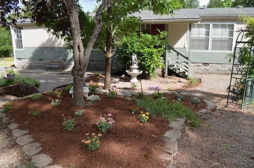 Beautiful secluded fenced 5 acres with Southern Exposure1992 3 bedroom two bathroom home with vaulted ceilings skylight, granite counters upgraded cook stove induction convection, upgraded washer and dryer certified wood stove Updated heat pump and a nice Deck to enjoy the pastoral setting. Brick and Mortar skirting , 26 by 32 garage/ shop with 220 and a carport. Mature landscaping and pretty flowers in the courtyard.  Amazing pond with irrigation rights that the wildlife love. Great location not too far from town.