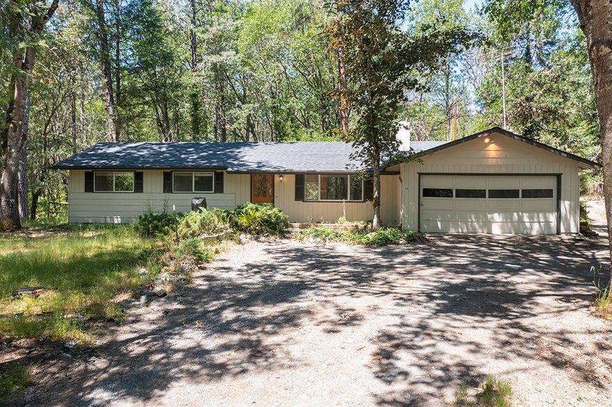 Looking for that private, wooded hideaway with land, room for critters and shop space?  Look no further!  Built in 1974, this 3 bedroom, 2 bath rancher features many modern upgrades including a heat pump & dual pane windows and boasts fresh paint inside and out, new roofing and kitchen range. 
 Roughly 2 acre dry-land pasture has a 2 stall barn, hay storage, and 2 steel paddocks.  The two shops were designed to work together for a former business and have over 1500 square feet of work space with a separate meter and breaker box.  Located on 5.56 acres just outside of Grants Pass, towards Murphy, you will love the privacy and convenience.
