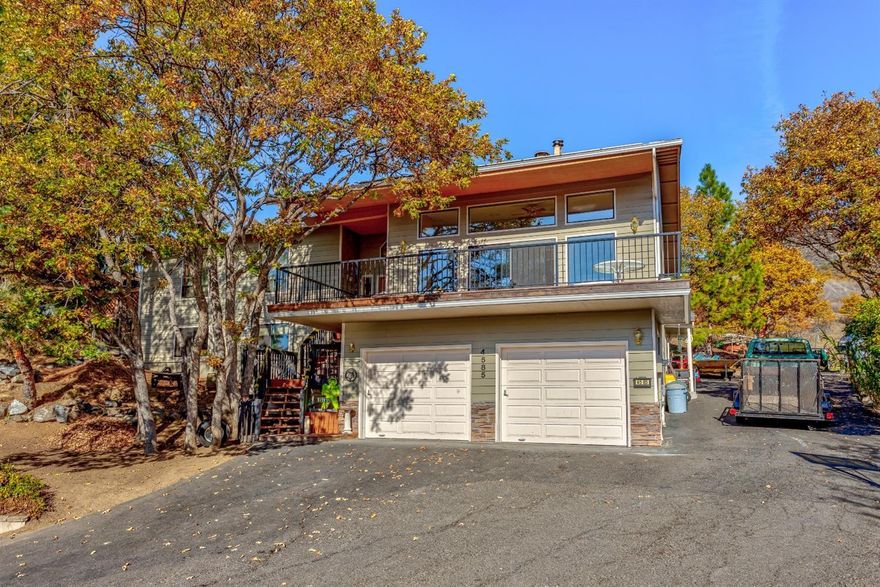 Room for all in this 5 bedroom, 4.5 bath home with pretty mountain views on large .29 acre lot! Enjoy power bill savings with approx. $35,000 solar system in place! Spacious, vaulted living room with stone fireplace. Large picture windows and oversized slider to deck. Large kitchen offers granite counters, island with eating bar, stainless steel appliances including smooth cooktop range/oven, microwave hood refrigerator and dishwasher. Dining area open to kitchen. Vaulted master suite with double sink vanity and two closets. Lower level bonus room. Attached 2 car garage plus RV parking.