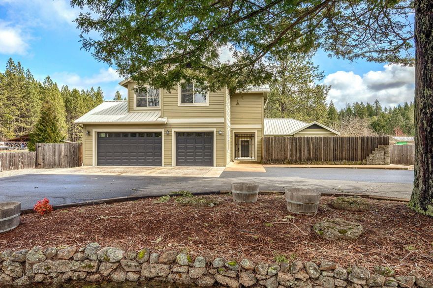 Beautiful 1 owner home. Amazing 4600 SQ FT w/4 full bathrooms with heated tile floors and granite counters. Beautiful kitchen with dbl convection ovens, granite counters, lg island that opens up to lg great rm w/vaulted ceilings wood-burning fireplace, laminate wood floors, French doors to a covered patio, plus a large extended deck. Main level primary bedroom w/walk-in closet, lg primary bathroom with Travertine tile floors and large travertine shower, double sinks with granite counters, water closet, soaking air jetted tub and a French door out to private covered patio, wired for hot tub. Upstairs has 5 bedrooms, 2 bthrms Upstairs open area over looking great room w/built-in office/desk area with a covered balcony. Full bath at bottom of the stairs. 3 car finished garage, solar elec. panels and back up propane generator. Electric gated entry with Stone entry with pave circle driveway with amazing redwood tree in circle. Private courtyard w/Rod iron entry gate w/stone water feature.