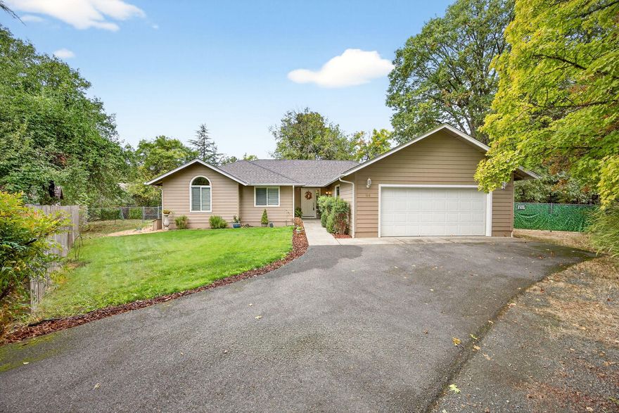 Creekside home on a .53-acre flag lot, making it private, yet it's right in town.  This lovely 1638 sq ft home sits on Gilbert Creek & features 3 bedrooms, 2 full baths, vaulted ceilings, open floor plan, hardwood floors & storage galore!  The spacious living room with gas fireplace for those cozy winter evenings & arched windows keep it light and bright—large kitchen with breakfast bar, built-in desk & pantry.  The primary suite features a walk-in closet, shower & separate soaking tub. The hall bath has dual sinks, while the laundry also has a sink & both have an abundance of cabinets.  There is a nice patio off the dining area overlooking the fenced yard, perfect for a garden, play area, pets, or whatever your imagination can dream of.  OR, simply sit in the back yard and enjoy the sound of the creek.  Other exterior features include 2-car attached garage, automatic irrigation & paved driveway.