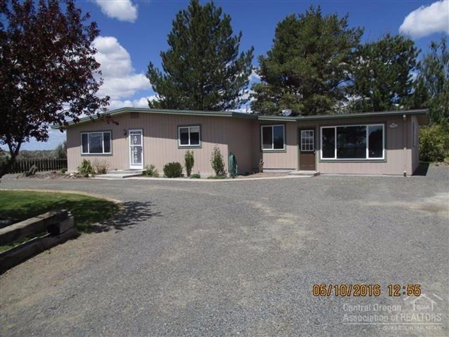 This is truly an oasis in the desert. Property includes 2 tax lots to allow for more room to grow or build a nice shop or garage. Many trees, shrubs & flowers adorn this property so you can sit & enjoy the evening breeze. Nice 2 BR/1Bath home w/a lg family room, & formal living room too. Some of the recent upgrades inc new vinyl windows, wall & baseboard heaters, kitchen sink, microwave, septic upgrades & more. Enjoy all the high desert has to offer. Owner will carry w/substantial down payment.