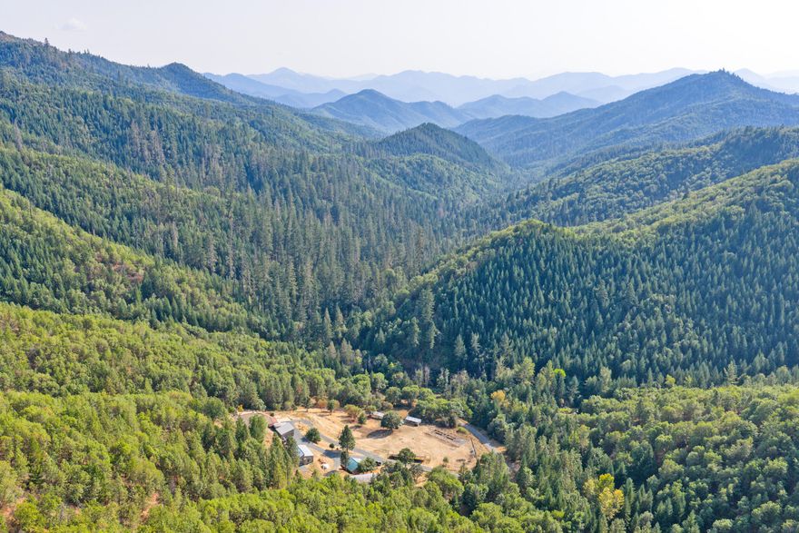 Stunning. Secure. Extraordinary. This remarkable off-grid estate was built for independence without compromise. It is ideal for those seeking a turnkey homestead, survival retreat or supreme privacy. Nearly $700k in upgrades include robust solar system with diesel backup, dual fuel hydronic heating, water storage system, a new well, upgraded septic, nuclear biological (NBC) filtration, perimeter iron fence/gate and so much more. The concrete Terra-Dom home blends strength and comfort, featuring a spacious primary suite, kitchen with full appliances, radiant heated floors and windows with picture-perfect mountain sunset views. Outdoors, a greenhouse, barn, gardens, pastures, animal shelters & seasonal creek support self-sufficiency, while a remodeled ADU provides add'l living space. Offered furnished, this rare property pairs stylish homesteading with true preparedness. Bordered by 500+ acres of USA land & minutes to town it is a lifestyle retreat unlike any other. Ask for Feature List