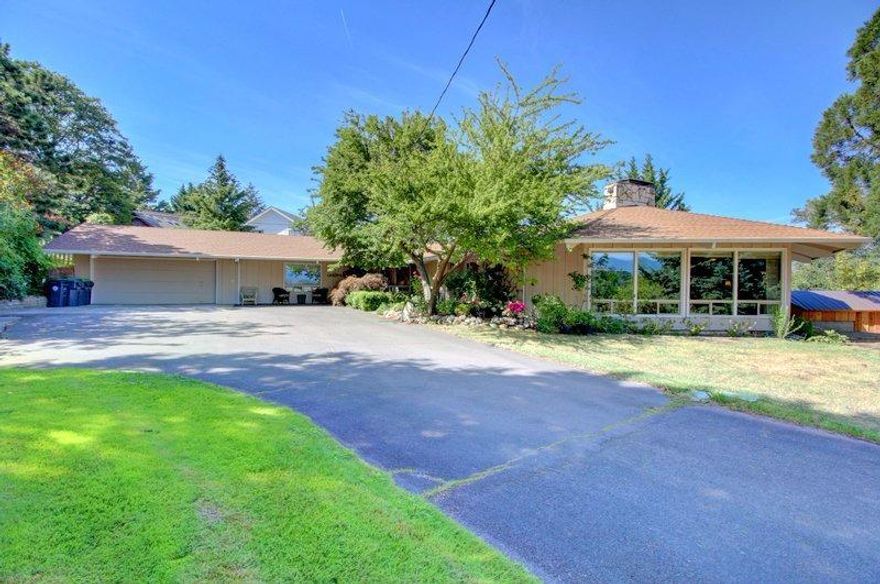 Truly a 1-of-a-Kind Opportunity with this Unique Mid-Century Dream Home W/Gorgeous In-ground Swimming Pool, Amazing Views & Incredible Location Just Seconds to the Manor! This one-story house is perfect for families and entertaining. Located minutes from medical facilities, schools, parks & shopping, this home sits on a huge 0.67-acre lot w/a large, beautiful back yard, attached finished 2-car garage, spacious kitchen & bright living room with huge vaulted ceilings. The back yard has great potential for a garden, plans for an outdoor kitchen area, patio, in-ground swimming pool trimmed by Pennsylvania blue stone w/surrounding deck, bonus garden shed/workshop & gorgeous views. The family room has lots of windows letting in tons of natural light, vaulted ceilings and double wood-burning fireplace. The huge kitchen in this house features an island w/bar seating, granite countertops & dining area w/views to the back yard. There are 2 cozy fireplaces, both wood-burning, plus full heating an