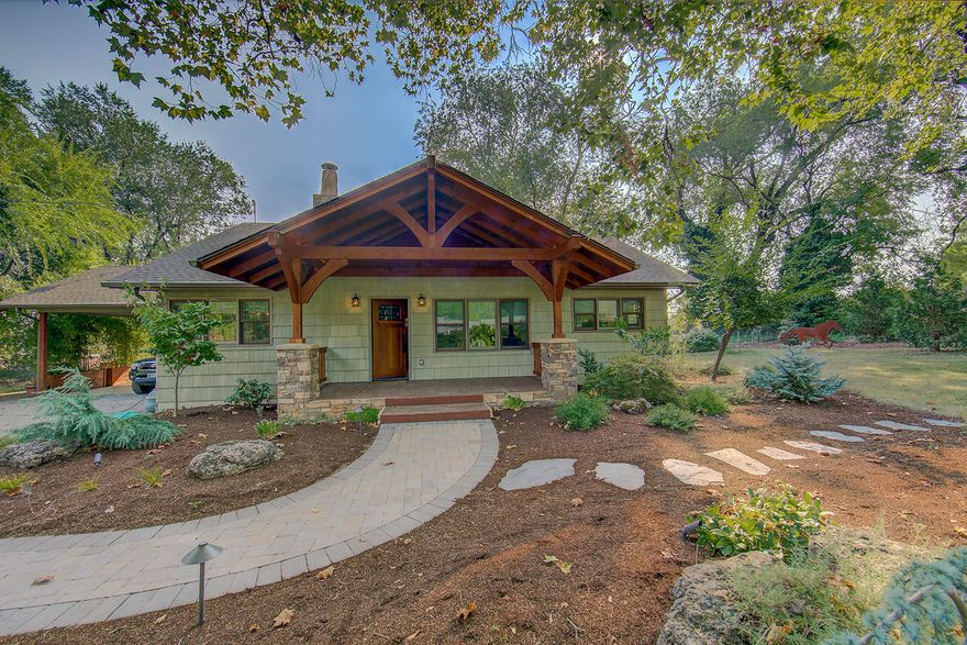 Warm and inviting country home with Craftsman style entry on beautiful .88 acre lot with mature trees. Lovely front porch sitting.  Quiet neighborhood of well maintained homes and lg country lots.  One level home with 3 bedrooms and 1 bath w/lots of charm.  Light filled dining area is new addition, permitted,  and 120 ft. not reflected in county assessors sq ft. Remodel in 2016 inc. new roof, front porch, insulation & whole house fan.  Kitchen & dining w/slate flooring,  new range, granite counter tops and alder cabinetry. Red oak flooring throughout rest of house. Entry to front room through beveled glass fir French doors.Wood burning fireplace w/gas starter. Master bedroom w/built-in closet organizer. Bathroom w/shower & deep soaking tub.   Property is well set up for dogs, horses and has RV parking pad. Surrounded by EFU property and pastures. Fruit trees inc. plum, apple, cherry & prune.  12'x16' weather proof storage barn. City electric & sewer. 5 min. drive to Jacksonville.