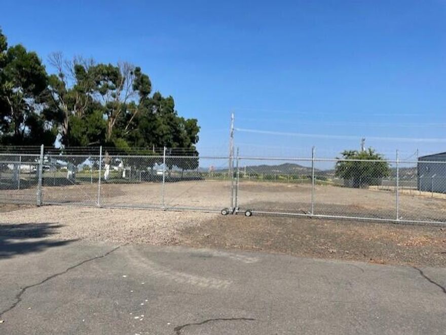 Fenced vacant lot in a Light Industrial Center.  The fenced area is approximately .71 of an acre.  Lot fronts Crater Lake Hwy and is Ideal for many uses.  Lot currently does not have utilities, however they are available.