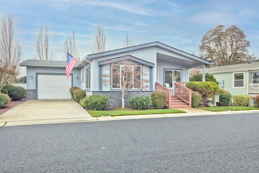 Beautiful, well maintained manufactured home in Westlake Village, the premier 55+ manufactured home park in the Grants Pass area. Not the typical manufactured home. You can't tell it is a manufactured home by looking at it. This is a 1440 Sq Ft, doublewide manufactured home with 2 bedrooms, 2 baths plus a den/office. Built in 2013. Easily maintained landscaping, with a covered patio on back of home and a comfortable, covered front porch.  The home has vaulted ceilings, a large pantry in the kitchen and an oversized single garage. The gas range, refrigerator, dishwasher, microwave, washer, and dryer are included.  Westlake village has a lake and recreation center. Close to downtown and Reinhard Volunteer Park. Seller offers $3,500 carpet allowance at close of escrow,