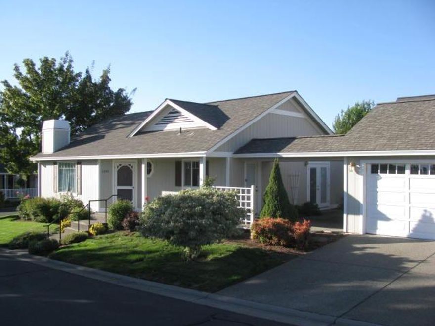 Great single level home in Country Club Village Estates! Open floor plan with vaulted ceilings in living area and both bedrooms. Home has tile floors in both bathrooms and kitchen, gas fireplace and a 2 car detached garage with a covered walkway to the house. Refrigerator and washer and dryer are included. Easy care landscape with a timed sprinkler system. Warm inviting home that is perfect for a small family or a retired couple wanting to downsize.