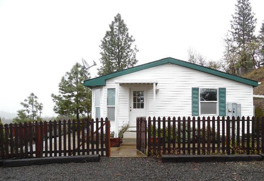 Picturesque 1107 sq ft single-level manufactured home in scenic Eagle Point hills. Outside there are raised garden beds, a detached shed, and a large deck. Indoors there are skylights in the kitchen, high ceilings throughout, comfortable soaking tubs, an inside laundry area. This move-in ready home sits on over 5 acres and definitely won't last long!