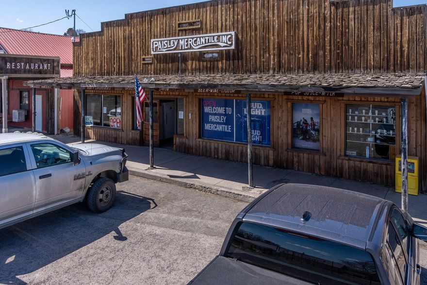 The Paisley Mercantile is a full-service business for the ranching and recreational town of Paisley, Oregon. Much like the general stores of old western towns of the 19th century the Paisley Mercantile services a large swath of rural Eastern Oregon with the essentials of rural life. Items included in this Old West big box store are cold drinks and groceries, hardware, household items, liquor, tobacco, health, beauty items, toys, pet food, plumbing, auto supplies, camping, fishing gear, tools, cleaning supplies, hot food, ice, Greeting cards, and more.! More than likely if you are in a pinch and within a 30-mile radius of Paisley, the Paisley Mercantile is your best and possibly only source for what you might need. Included with the Paisley Mercantile is well cared-for a 1944 ± square foot 3 bedroom/2 bath home with a large deck and back yard on a separate tax lot and a 900± square foot metal shop with concrete slab and loft. The business could be owner-operator or investor.