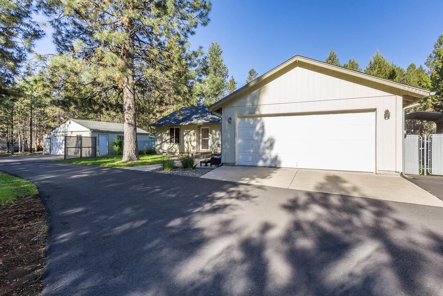 Truly a gardeners dream! This home has been so wonderfully landscaped throughout the whole acre. The owner is a gardener by trade and every plant really has a purpose! Light and bright 3 bedroom 2 bath home nestled right in the middle of what feels like a secret garden! From onions and asparagus, to more exotic plants, this is really a home you can sit back and enjoy. Accompanying this home is a 24x24 workshop, 18x36 RV cover that has a power outlet, and a 10x16 storage shed. The side of the home offers an RV electric outlet, and so much more.  Property is completely fenced and gated. This house truly is a must see!