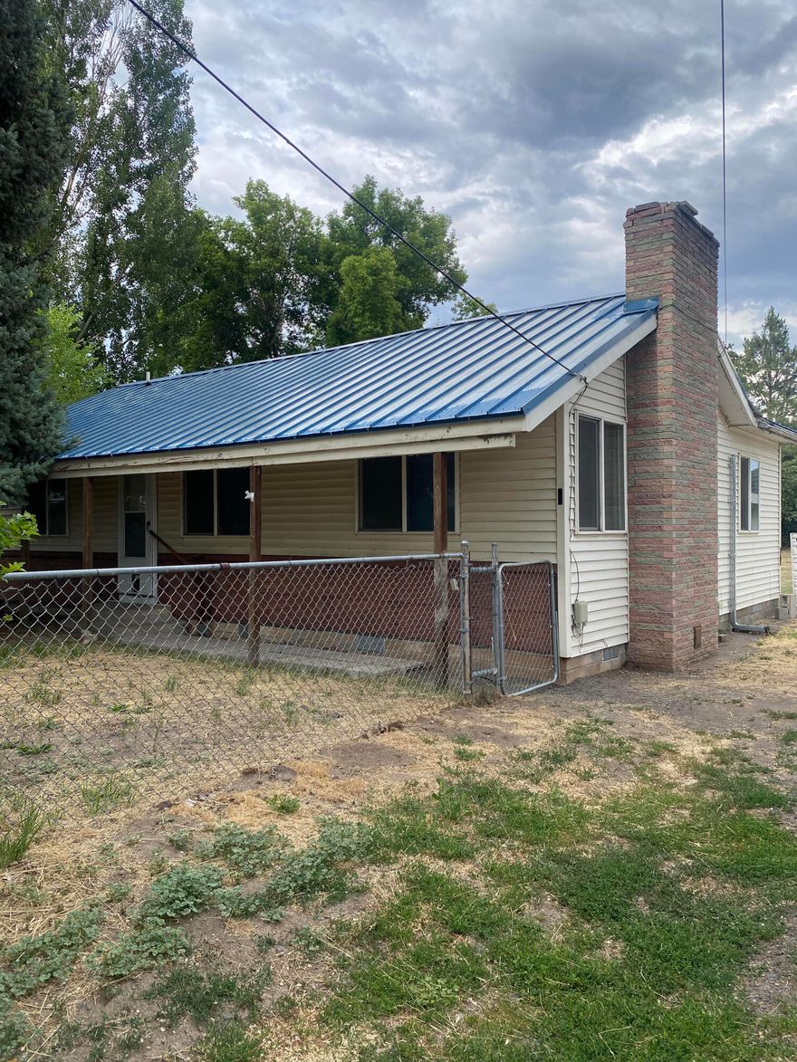 3 bedroom 1.5  bath home ready for your imagination and touches Or , live in as is !  Fireplace in the living room, dining area and galley kitchen.  Central A/C, laundry room with walk out door to the large backyard. This property is completely fenced front and backyards. Solar panels, Detached garage with shop, and a storage shed.