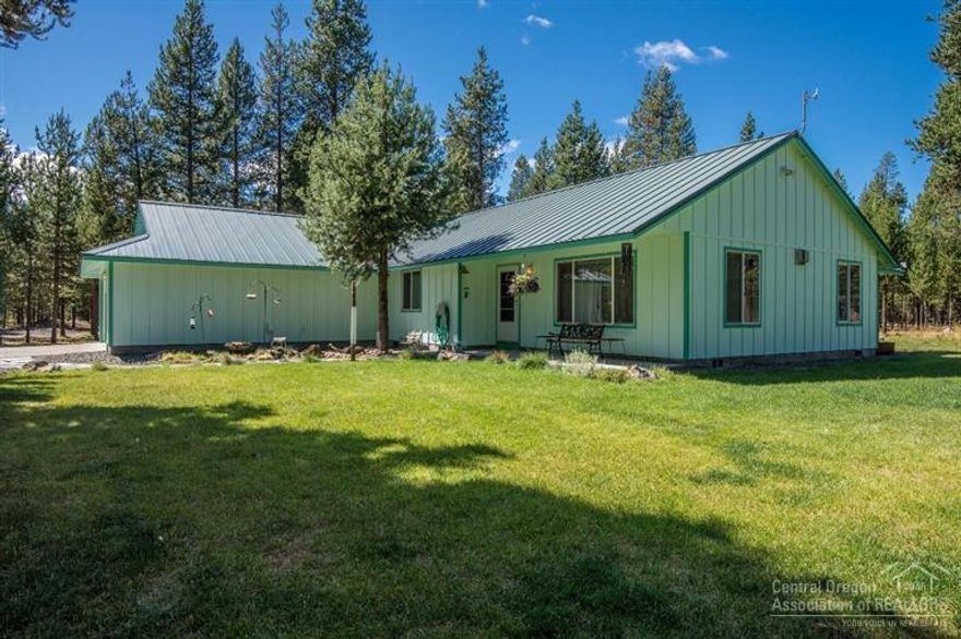 Custom SINGLE LEVEL home on almost 5 acres. This very private setting boasts 1735 square feet home with high end appliances, beautiful wood cabinets, tons of natural light and a desired open floor plan. Fully insulated 30 x 40 foot shop and extensive workbench. Covered RV parking with electrical and septic dump area. The rest of the property is well trimmed, maintained and is a nice mix of fir and ponderosa, there is an enclosed garden and large deck to enjoy the expanse woods, nature in complete privacy.