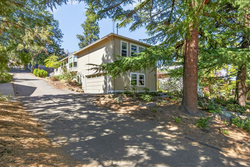 Well maintained home with a desirable location, just blocks from beautiful downtown Ashland, Oregon. First time on the market since it was built in 1990, this lovely home has a lot to offer. Upon arriving you are met by a grand Deodar Cedar tree adorned with tastefully landscaped areas crafted by Solid Ground Landscaping. Covered front porch leads to a lower-level living room w/ tall ceiling and a cozy gas fireplace. Kitchen is open to the dining area and main level family room w/ access to the side yard deck and gorgeous patio area. Well-designed floor plan of approx. 1667 SF, has a good feel to it, unique architectural features and tasteful updates over the years. Three bedrooms and two bathrooms, the primary bedroom suite is on one end, and the two additional bedrooms and full bath on the other. The back and side yard areas are fenced in and provide a wonderful atmosphere for outdoor relaxation and enjoyment. Overall, just a great house to call home!