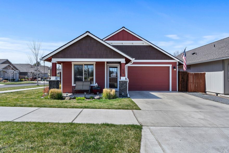 Don't miss this immaculately maintained single-level home on a spacious corner lot in NE Bend! Covered front porch entry leads into an open, airy layout w/vaulted ceilings, stunning stone fireplace, & an abundance of natural lighting throughout. Kitchen features a large island, tiled counters, corner pantry, & stainless appliances, flowing into a spacious dining area—perfect for entertaining. Well appointed & spacious private primary suite features a luxurious brand new dual head LuxStone walk-in shower (22k upgrade)! Additional bedrooms share a full bath w/step-in shower! Sliding glass door off main living space leads to a private patio for quiet mornings/evening entertaining. Enjoy beautiful low maintenance landscaping, fully fenced backyard w/serene water feature & plenty of room to host. Bonus garden shed adds extra storage. Central A/C! Located near restaurants, immaculate parks, plenty of trails, grocery stores, gas stations & medical facilities. Call today to schedule a showin