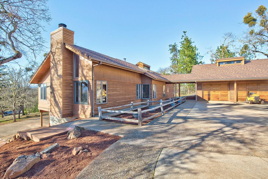 This beautiful property checks all the boxes! Enjoy breathtaking views of the surrounding mountains from this usable 5.44 acres. Spacious 3,036 sq. ft home offers an open floor plan with vaulted ceilings, gorgeous hardwood flooring & abundance of windows. Kitchen features updated appliances & delightful old-fashioned stove. Master with vaulted ceilings, fireplace & french doors to deck. Two additional bedrooms upstairs, each with deck access. Downstairs could be 4th bedroom, entertaining space, or possible two family set up. This area features a wood stove, newer laminate flooring & cabinets, its own bathroom and small kitchen area, as well as a wine cellar and access to an oversized 1 car garage/shop. RV parking with hookups and an additional 2 car detached garage. Additional shop with improvements at the top of the property. Fenced garden area, chicken coop, greenhouse, grape vines and woodshed are also included in all this property has to offer. Make your appointment to view today!