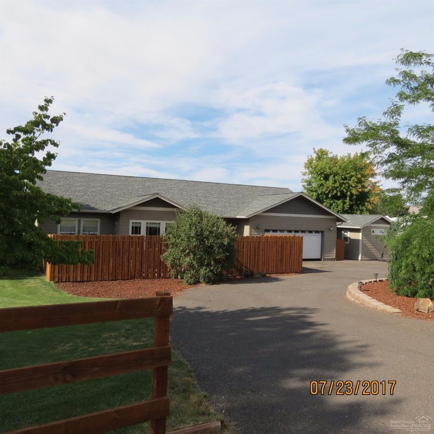 Beautiful single story home on .60 of an acre. Jefferson, Hood, 3-Finger Jack, and Smith Rock Views. This home boasts Tile floors, cheery sun-room with wood floor, a pantry, 2-walk-in closets in master, den, and a propane fireplace. RV PARKING, Fenced, Hardi-plank siding, rain gutters, manicured yard, front & back porch areas, 12x12 newly finished & heated craft/art studio, water feature, and HOT TUB. With a Double Garage, extra insulation in attic and garage. Great Location! Room to build a barn or shop!