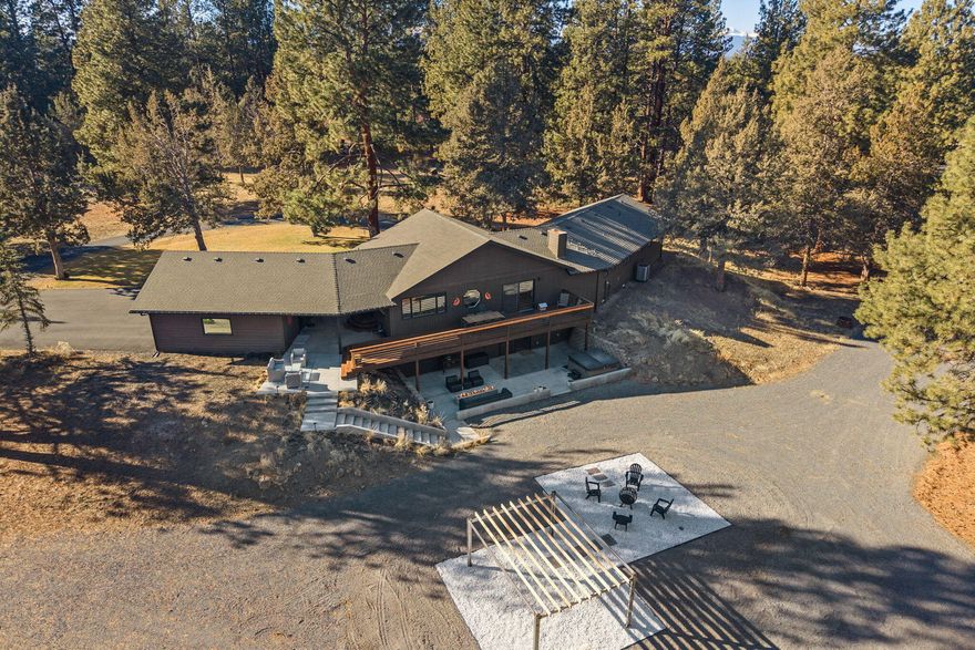 This beautifully renovated contemporary retreat on 5 serene acres is complete with a detached studio and horse barn. The spacious great room is a show stopper with vaulted ceilings, exposed beams & walls of windows. The gorgeous kitchen features a Liebherr wine fridge, top of the line Dacor appliances & waterfall island. The main floor primary suite offers a fabulous bath with walk-in shower, while 2 additional bedrooms share a luxurious wet room with a soaking tub & shower. The lower level is perfect for entertaining with a kitchenette, bedroom, full bath, & access to a private patio with a hot tub & concrete fire table. The 400 SF studio provides a versatile space for work or creativity, with heating, cooling, and 220V outlets.  If you don't have horses, you could convert the 3-stall barn to a dream shop. 2 acres of Irrigation water rights and a greenhouse are added bonuses to this perfect sized property.