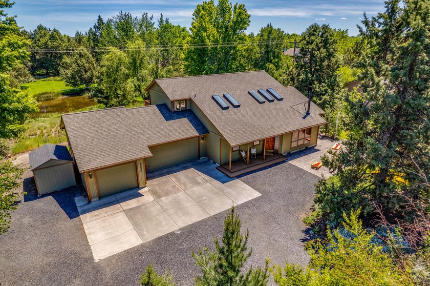 If you value privacy, recreation & convenience, look no more! Located 1 mile to Cascade Village Shopping Center, 4 miles to Downtown Bend and Drake Park. Easy access to Hwy. 97 & Hwy. 20. This beautiful & private .50-acre property is fully fenced w/ gate access. RV space with FULL RV hookups including a small  yard & paver entrance for guests. The 1986 custom-built home is placed perfectly to add to the privacy while enjoying stunning views of a pond, wildflowers, and mature aspens. You can enjoy all this off of the expansive back patio w/ an added wood-burning fire pit. Inside offers 3 bedrooms (one bedroom downstairs) and 2 bathrooms (one upstairs, one downstairs). The kitchen & dining adjoin a large great room with a vaulted ceiling & wood-burning stove. The downstairs south-facing sunroom can be used for an additional workspace, workout room, or indoor garden. 3-car garage with 3rd bay as a garage/shop measures 12X30, heated, plumbed, 110 & 220 power & pull down staircase to attic.