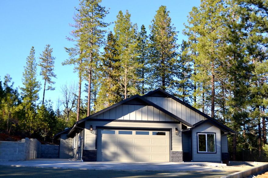 Rare brand new custom quality home on acreage. All the homes around this one by the same builder have sold for more money. This elegent NW style home has a wealth of quality features and is set up for a low maintenance lifestyle. It features a great well and brand new septic.  The home was just completed including automatic gate and paved driveway.  You will be impressed with the floor plan and the latest features and colors as well as the energy efficiency. . Check it out and you will see the value.  Wonderful views and secluded feel for a great price.