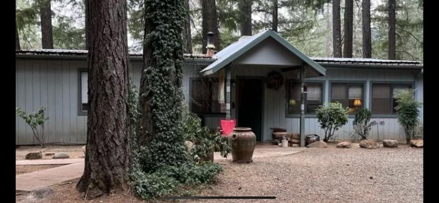 2 Family Set Up in a tranquill forested location. What we have is a 2,015 square foot home with 3 bedrooms and 2 bathrooms. Updates have been made to the bathroom, new forced heat and air in addition to the certiified wood stove, swamp cooler and new cadet wall heater. The main suite has a walk in closet and the kitchen features a gas stove.  The additional dwelling of 920 square feet seems much larger with its niice full kitchen and has 2 bedrooms and 1 nice sized bathroom., with its own power meter and septic. Both homes come with all appliances. This property is fully fenced and has an automatic gate,. The park like grounds offer many fruit trees and there are sprinklers to help you with the watering and its backed by a 15 gallon per minute well, there is also a second well, but not in use. RV space is ready with hook ups and there is a generator for emergency. Lots to offer/