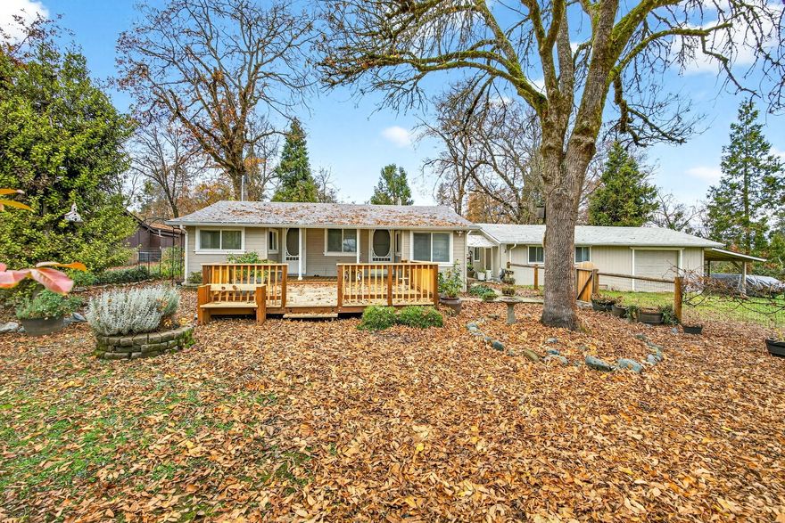 Updated and move-in ready! Tucked back off the street, this property offers two separate living spaces - the main 2-bedroom, 1-bath home plus a detached 800 sq ft garage with a finished bonus room, walk-in pantry and a permitted bathroom - perfect for guests, hobbies, or rental use. The .32-acre property includes a newer roof, deck, flooring, and septic, along with mini-splits in both buildings. Inside the main home, you'll enjoy a cozy pellet stove in the living room and two office/reading nooks for added flexibility. With fenced front and back yards, RV parking, plenty of outdoor space, and easy access to I-5, this property is full of opportunity.