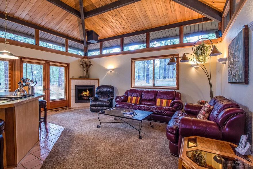 Charming 2 bedroom home a short walk from the Village in Sunriver! 360 degree clerestory windows and double sets of french doors that open the north wall of the great room to the spacious composit deck add character and expand your living area. Corner lot backs to a great common area for added privacy. Wood clad windows and doors, and vaulted, tounge and groove ceilings with exposed beams run throughout the home. Stay cool with A/C or cozy up to the gas fireplace on chilly nights. Soak under the stars in the private hot tub then retreat inside to the two bedrooms - each comfortably appointed. 3 exterior storage closets allow for great additional space to stash bikes and gear. Active short-term vacation rental with excellent history. Turnkey furnished and ready to enjoy!