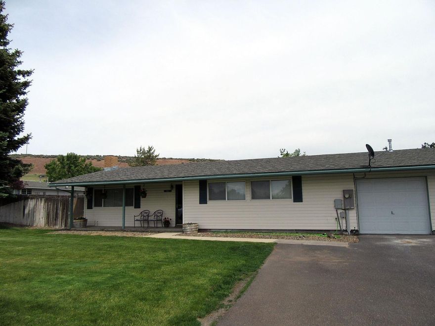 Carefree living in this great gated community that is a little bit country but short distance from town. 3 bedrooms, 1 remodeled bathroom, vinyl siding and vinyl windows. All appliances including washer & dryer stay. Center garage, large fenced back yard with alley access for parking RV'S. All Henley schools.