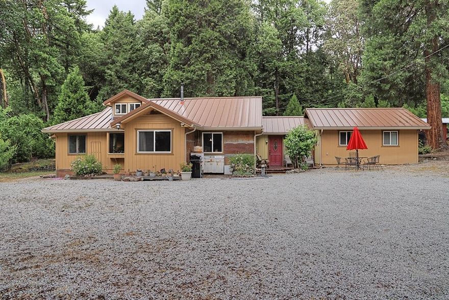 Exceptional Country Contemporary Home & Property on just under an Acre of Level Land! Located on a Quiet Country Road. This Home has been wonderfully & recently Updated & Remodeled, showcasing a Fantastic Contemporary Kitchen with Stainless Appliances, Fixtures, and Appliances. Enjoy a Huge Living Room with Woodstove, and an Open Living Concept between the Kitchen, Living, and Dining Areas. Home offers a Charming Master Bedroom with Rock and Wood Accents. Nice Additional Guest Bedroom, plus Two Additional Rooms permitted as Living Space that could easily be utilized as Bedrooms. This Home is Light & Bright on the Interior & is just overall extremely Comfortable & Welcoming. Outbuildings include a Multi-Purpose Workshop Building and Woodshed. Plenty of Parking and Turn-Around for Trailers, RV's, etc. Quality Metal Roof. Property Directly Adjoins Wolf Creek Park, and is walking distance to Library and Award-Winning Charter School. 20 Minute Drive to Grants Pass. So nice in every aspect!