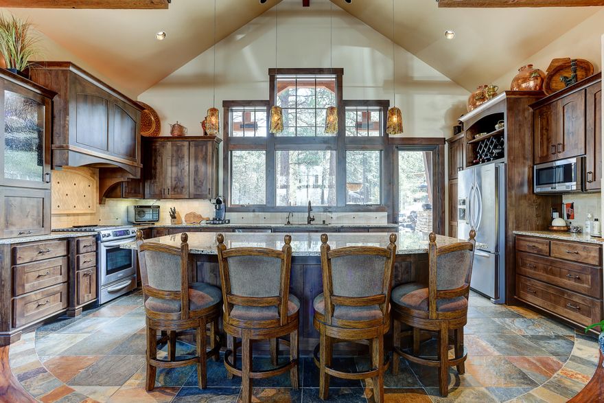 A Beautiful 4 BR, single level custom NW mountain home built by Sun Forest in Caldera Springs, Central Oregon's top rated destination resort community. Take in the mountain views from living room & bedroom, custom light fixtures and thoughtfully designed beam work that parallels the highly appointed Caldera Springs Lake House design. Stunning copper accents throughout the interior & exterior.  A timeless design like no other with no details overlooked in this home.
One of the en-suites has a dedicated private entrance and option to lock off from main home; a spacious, fully equipped guest suite with a full bath, kitchenette and outdoor patio access. Equipped with smart home features, 4-zone heating, motorized blinds and heated bath floors in primary & guest suites and kitchen. Enjoy outdoor living on the covered back patio while taking in the breathtaking forest and water feature views.