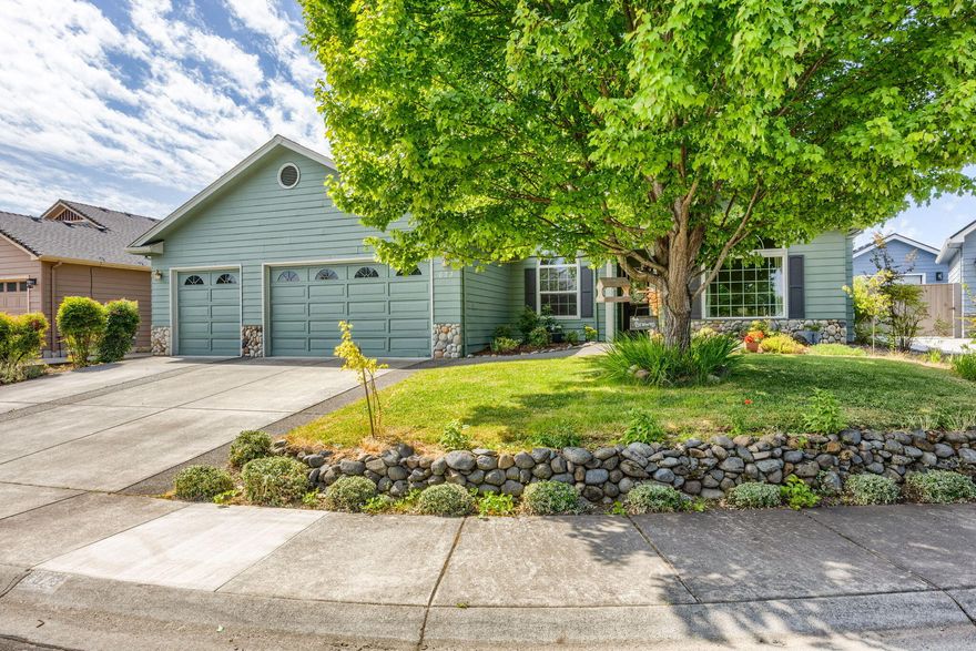 This turnkey home is located in one of Central Point's most desirable neighborhoods, surrounded by well-kept homes on a quiet street. Beautifully landscaped and well-maintained, it features a 3-car garage with workbench and a functional, flexible floor plan. The spacious living room is filled with natural light and offers vaulted ceilings and a gas fireplace. A versatile dining area can double as a family room, and the breakfast nook opens to a private covered patio. The kitchen is equipped with upgraded Samsung white-glass appliances and offers easy flow between indoor and outdoor spaces - ideal for both everyday living and entertaining. The backyard is a peaceful retreat with mature landscaping and a dedicated garden bed for vegetables or flowers. Guest bedrooms are generously sized, and the guest bath is brightened by a skylight. The primary suite includes a walk-in closet, dual vanity, soaking tub, walk-in shower, and access to a private covered patio. Move-in ready!