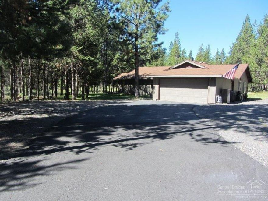 Nestled on 1.33 acres & backing to Forest Land for your year around recreation & privacy. Short distant to Sunriver & Mt Bachelor & high lakes. The home has vaulted ceiling in great room & wood stove. New quartz counters in the kitchen, island, large pantry & patio off the dining to outdoors. Additional room off the master. 1200 sqft Shop building & carport w/bonus area studio or guest quarters w/full bath. Storage building included. Seller installing new roof. Home has 2 bed & 2 bath, shop 1 bed & 1 bath.