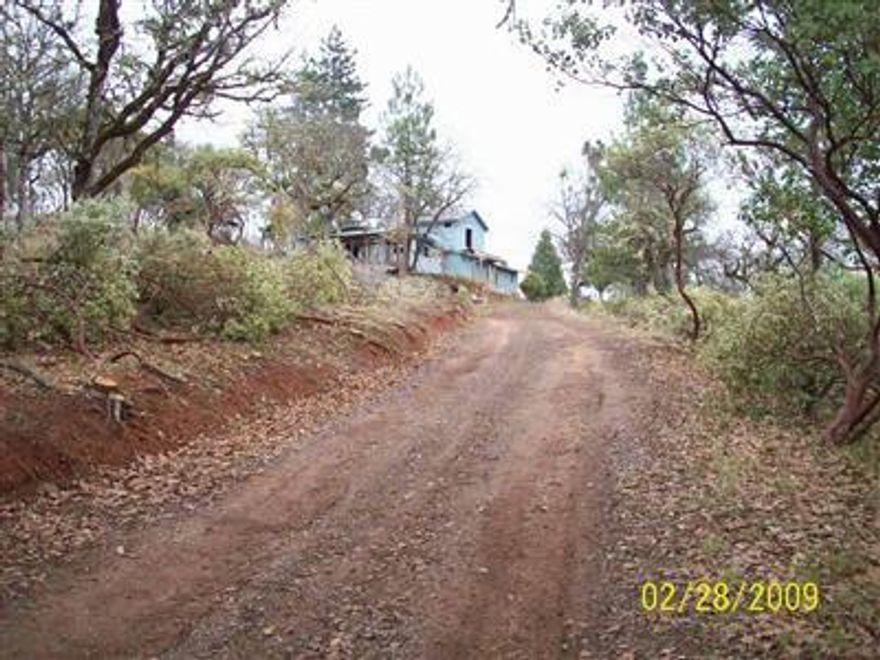 Nice rural setting. Value is in the land. Home has been damaged by fire. Home & property being sold AS IS Present condition. Buyers to do own due diligence. Please use caution when touring property. Seller and/or agents shall not be liable for any injury. Please be careful!