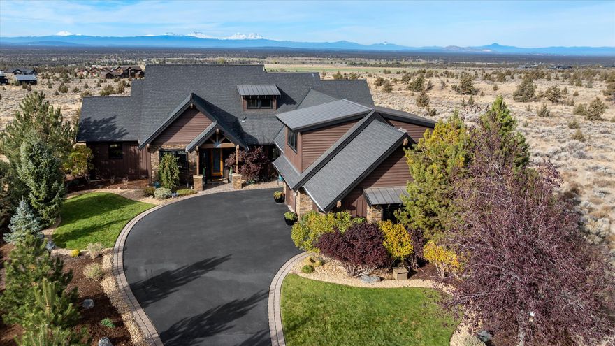 Stunning Cascade Mountain views abound at this NW Style home that is perfectly situated within Brasada Ranch. You are greeted with vast panoramic views of the Cascade Mountains from the large windows in the great room that features a vaulted ceiling & custom built-ins that surround the stone fireplace. This open floor plan flows to the kitchen/dining area with custom cabinetry, high efficiency appliances, & a roomy pantry. Beyond the doors to the rear, is a large patio with an outdoor kitchen area, gas fire pit, expansive common space to take in Brasada's natural terrain & mesmerizing sunsets. The primary bedroom is positioned to offer expansive mountain views as well with its private patio access while blending a rustic warmth provided by the fireplace. Upstairs you will find two additional bedrooms, one featuring an ensuite bathroom, a large media room, & storage closet. A beautifully finished three bay garage completes this home.