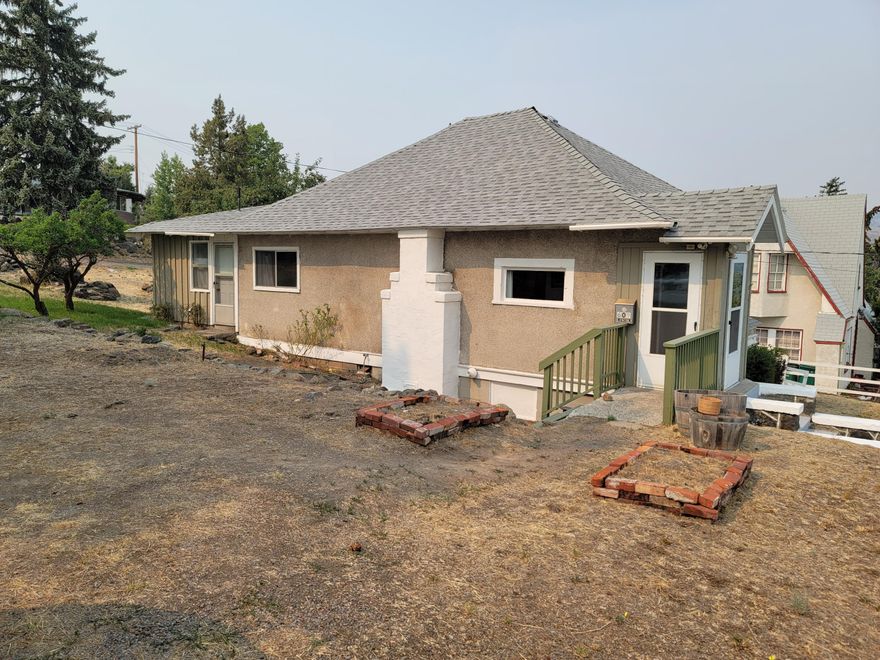 Perched hilltop, this cottage style home will surprise you. The double lot allows for extra parking or for future expansion. Picturesque rock walls border part of the back boundary and along the sidewalk in front of the property. Large master bedroom with walk-in closet. Spacious living room with high ceilings. Big, open kitchen with plenty of cabinet space. Fenced front yard and open back yard with multiple fruit bearing trees. Just a minutes drive from downtown Klamath Falls, and less than 10 minutes drive to most places in town.

Fireplace is capped.