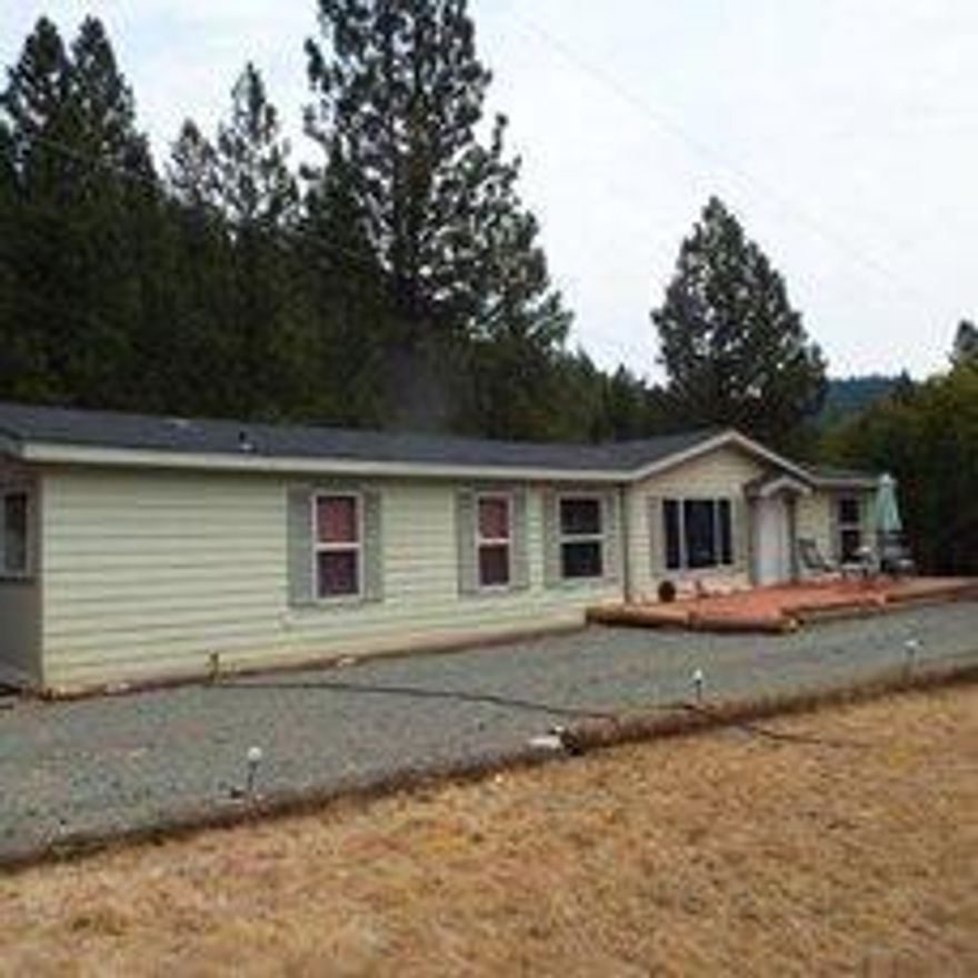 If you desire privacy and quiet living this is it! Beautiful and secluded. Build your dream home or live in this very nice manufactured home. Approximately 20 acres of flat land and beautiful wooded hill sides, roads throughout the property makes easy access to the property. There is a seasonal creek with 3 ponds on the property. Owner states he has recovered approximately 20 ounces of gold.