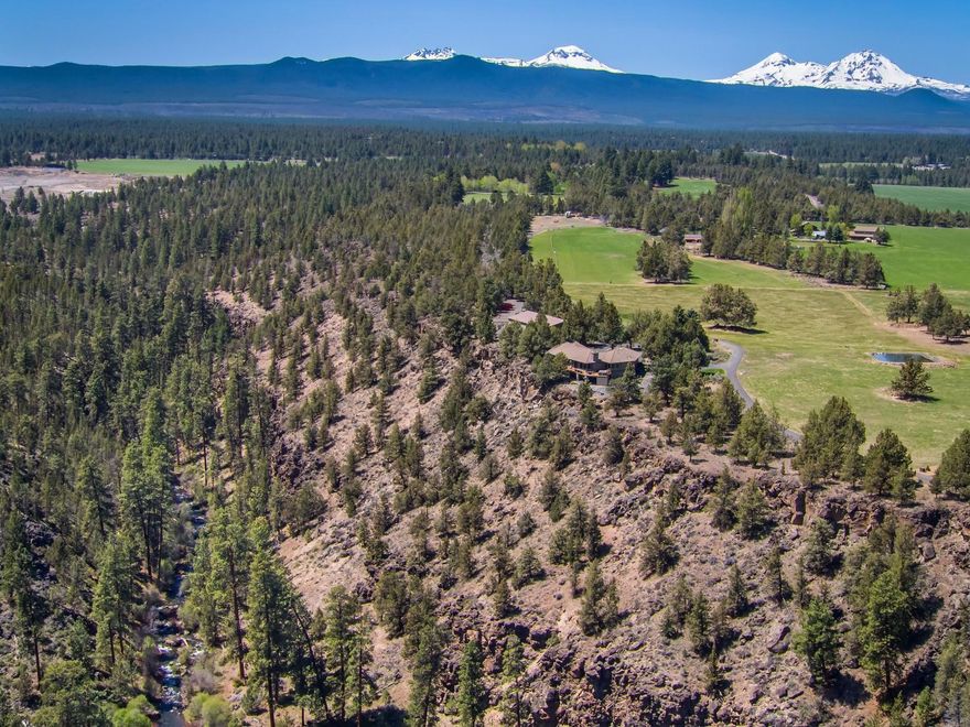 Two Rivers Ranch is a beautiful home with stunning views and access to the Deschutes River and Tumalo Creek. Custom, recently updated contemporary home is 4178 sq ft, 5 bedrooms, 3 bathrooms, living room with stone wood burning fireplace, gourmet kitchen, rare stone granite countertops, quality SS appliances, formal dining room, breakfast nook, family room, master suite with sitting area,  steam shower, game room, home gym area, wine room, utility room, and attached 2 car garage with gear room. Outdoor living includes hot tub on the deck overlooking river, creek and Cascade Mountain Views, raised bed garden, grass fields and fire pit. Shop is 5000 sq ft: workshop, upstairs studio, and RV storage. The property is 17 acres with 14.6 acres of TID irrigation water rights with automatic in-ground sprinkler system, lined pond, 2 chicken coops and an area for a future barn/additional outbuilding. This Tumalo Estate is an opportunity to own a one of a kind recreational, lifestyle property!