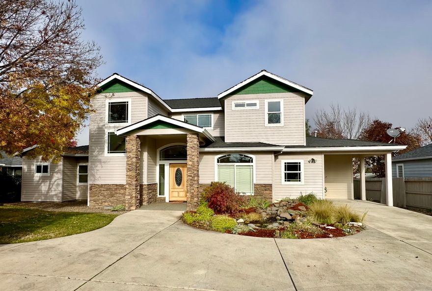 There is so much to love about this East Medford home including an over-sized 4-car detached garage with heated/cooled office/workshop, RV parking, mature landscaping with pond, fenced backyard, covered patios, main level primary bedroom suite, hardwood floors and so much more, all tucked away on a private flag drive. With 2,578 sf, 4 bedrooms and 3 bathrooms, this home welcomes you into the light-filled foyer and living room with soaring ceilings and large picture windows framing a gas fireplace. The spacious kitchen and dining area boasts granite countertops, breakfast bar, bay window and pantry. Enjoy lots of natural light in the primary suite with ensuite bathroom including tile floors, tiled shower and tile countertops with two sinks, plus a large walk-in closet and water closet. Upstairs you'll find two bedrooms, one with a walk-in closet, both with lovely neighborhood views, and a full bathroom. Lovely front and back yard spaces with manicured lawns. Excellent central location.