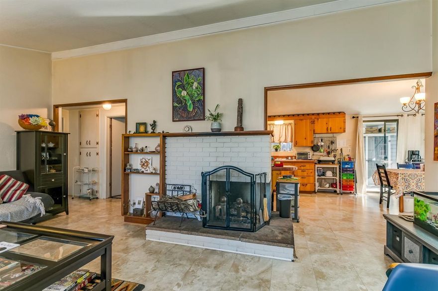 This is a great home! Cute and affordable single level home. This home provides a warm and open interior. Lots of charm for this open floor plan with wood burning fireplace that is open to the living room, dining room and kitchen. The vaulted ceiling gives a great sense of openness and spaciousness. This corner lot has a patio area, roses, mature trees and raised beds. Stacked washer dryer are included in the sale. Total of 3 bedrooms and 1 bath. Newer roof and the carport provides off street parking. Room for expansion. Very sweet and won't last at this price.