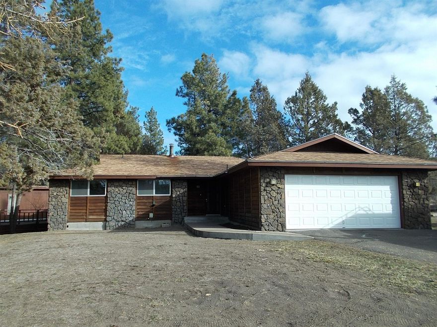 Built in 1974 this 3 bedrm, 2 bath is in one of the nicer neighborhoods in Bly. Good layout including living rm, dining rm, family rm with glass doors going out to a covered porch. Closet in the entryway, master tucked at the back of the house, plenty of storage closets, both a fireplace insert and a woodstove for heating. Property has a building just for an indoor pool and hot tub. Being used as a storage building, but remove the boards and there is a pool! Outdoor living space with tiered decking and concrete patios overlooking the common area. Attached 2 car garage, plenty of parking for toys plus room to build a shop.