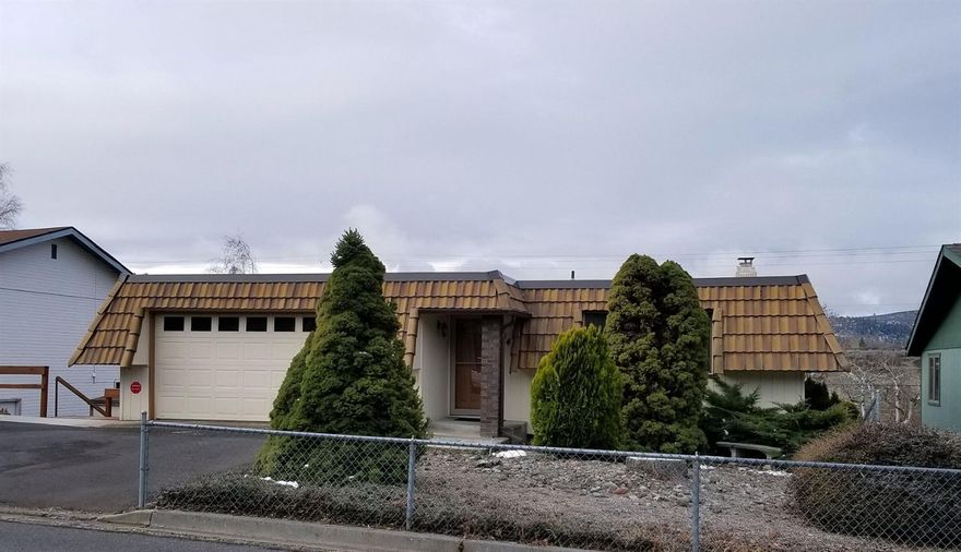 Well maintained 3 bedroom, 2 bath home with vinyl windows, large formal living room , plus family room open to the dining area and a country kitchen with eating bar, appliances and pantry. There is an extra hobby room/office downstairs. Gas heat and A/C. 2 car garage, with work bench, paved RV parking, lower and upper decks with amazing views of Mountains and city lights. Plus 12x12 storage shed. Close to OIT and Skylakes. Move in ready!