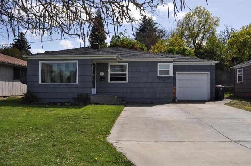 Cute East Medford home in great location! Very conveniently located to town, parks, schools and shopping. Home features: family room with fireplace; dining room; hardwood floors; 2 good sized bedrooms; great full bath in retro colors; indoor laundry room with storage; quaint kitchen with windows over the sink; upgraded electrical; and newer roof. Nice view of greenspace across from home with Hedrick's track. Home is set back from the street with a huge front yard and long driveway. Nice, fenced backyard with mature shade trees and a covered patio. So much potential here! Would be great for a first time home buyer or investor.