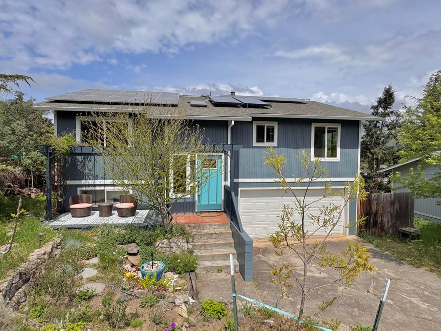 Be wowed by the views from this light, bright, move-in ready home in a quiet, convenient neighborhood. The split-level floor plan offers separation of space and investment potential; 3 bedroom, 2 bathroom upper level is a cozy home with an updated kitchen, wood burning fireplace and balcony deck off the living area. The lower level is 1 bedroom, 1 bathroom provides additional space or rental opportunity with kitchenette and exterior rear entrance. The tiered usable backyard with a flat paver stone terrace, is fenced, has large colorful plant pots, electricity for spa, fruit & flowering trees and drip irrigation. The high producing owned solar array and oversized 2 car garage round out this ideal property. Recent home updates include roof, HVAC, windows, appliances, hot water heater, paint and fixtures. This is a great 2 unit investment or place to call home. Features sheet is attached.