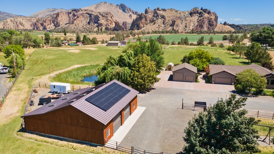 The Country Home You've Been Waiting For! Enjoy sweeping views of Smith Rock and Monkey Face from your backyard while sipping morning coffee in the sun or relaxing in the shaded afternoons on the covered paver patio. Tucked away at the end of a quiet road, this private 5+ acre retreat offers serenity, wildlife, and space to roam. The warm, light-filled home features Knotty Alder kitchen cabinets and wood accents, and an open layout. Recent updates include Milgard windows, Therma-Tru doors, refinished hardwood floors, and fresh interior/exterior paint (2023). Bring your animals and hobbies this property has irrigated pasture, a pond with dock, greenhouse, RV parking, and two finished-heated shops (25x30 and 50x50), one designed for easy horse stall conversion. Solar panels installed in 2024 feed back to Pacific Power. Minutes from Redmond and close to hiking at Smith Rock. Homes like this rarely come available! don't miss your chance!