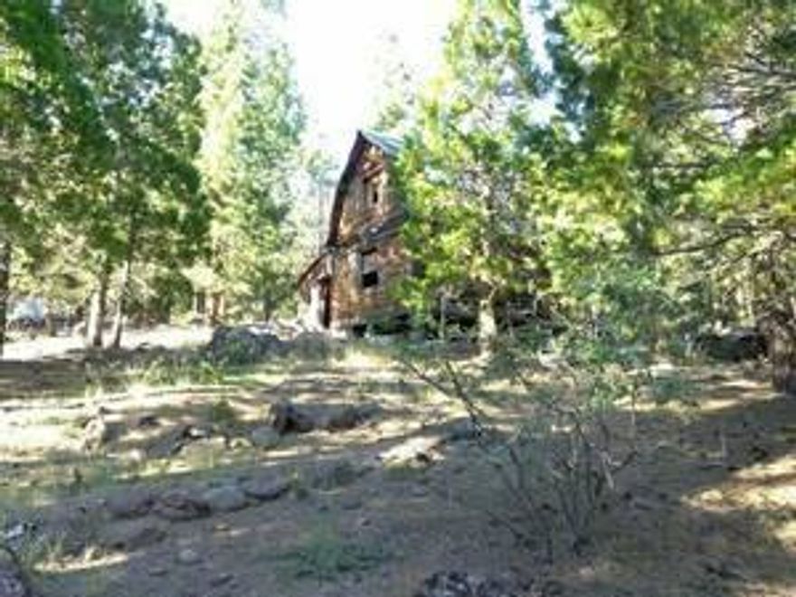 A beautiful area for a secluded getaway retreat. County records indicate 2 story cabin was built in 1985 but has since fallen into a state of dis-repair. There are 2.31 acres of beautiful land including many large and smaller trees. This listing is priced at land only with no improvements, however there is a two story cabin that reportedly was built by an Alaskan craftsman and situated partly on a rock foundation. Due to safety reasons seller requests no entry be made into cabin or adjacent outbuildings. There is no water or septic system on the county records but current owner has some knowledge of the old systems. Disclaimer: property information is deemed to be reliable but Buyer(s) to do their own due diligence.