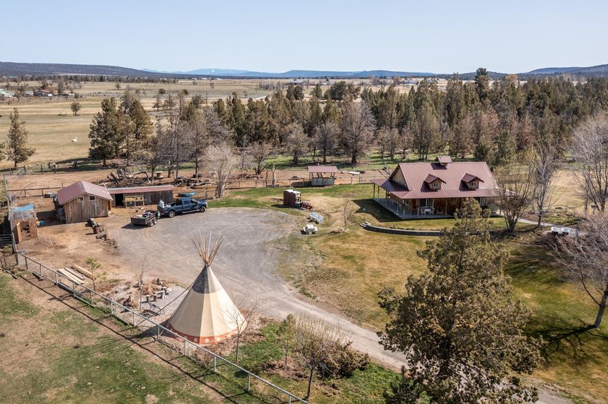 Turn-key, working farm in a great location between Redmond & Prineville. Views of the Cascade Mountains on this 35.49 acres w/22 acres of irrigation, grass hay fields. Home is a 4 BED, 2 BTH single level 1,920 sq ft. w/laminate wood floors, propane fireplace, custom blinds, large kitchen w/stainless steel appliances & mud room. Incredible landscaped yard w/ paver patio, fire pit & entertaining space.  Stunning new barn w/pellet stove, bonus room for guests, blue pine tongue+groove ceilings, stall & tack room. 24x36 shop w/ wood stove, office/hobby room, 220v power, loft storage. 2 greenhouses (one commercial sized). Chicken coop,  lean-tos, birthing room, stalls, multiple pastures w/nice no-climb fencing. Teepee & RV space used for airbnb guests w/power & water hookups. Large hickory shed set up like a store for selling farm goods, use as home office, guest cottage, possibilities are endless. Grounds are beautiful w/ trees, plants, green grass. Call for your personal tour!