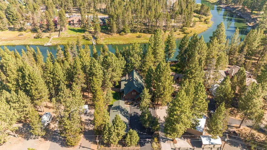 Exquisite .52/acre RIVERFRONT property on the Big Deschutes. Featuring 80 ft of private riverfront access, paddleboard, kayak or flyfish from this spectacular oasis. This custom log home is less than 30 minutes from Downtown Bend! The spacious Great Rm offers classic log architecture throughout, vaulted ceilings, wood burning floor-to-ceiling stone fireplace, & endless river views. Chef's kitchen w/ concrete countertops, SS Wolf appliances, farm sink, & solid wood breakfast bar. Dining area features direct access to wrap-around-porch, beautifully landscaped yard, paver patio & easy access to the river. The handcrafted staircase leads to the Primary Suite with balcony, vaulted ceilings, dual vanity, tile shower, clawfoot tub, & walk-in closet. Spacious loft/bonus room with large balcony. Main level Guest Room & full bath. Oversized Mud Room. Detached 312 sf studio with woodstove, & remodeled full bath. 3-car detached garage for all your Bend gear. RV parking. Short-term rental eligible