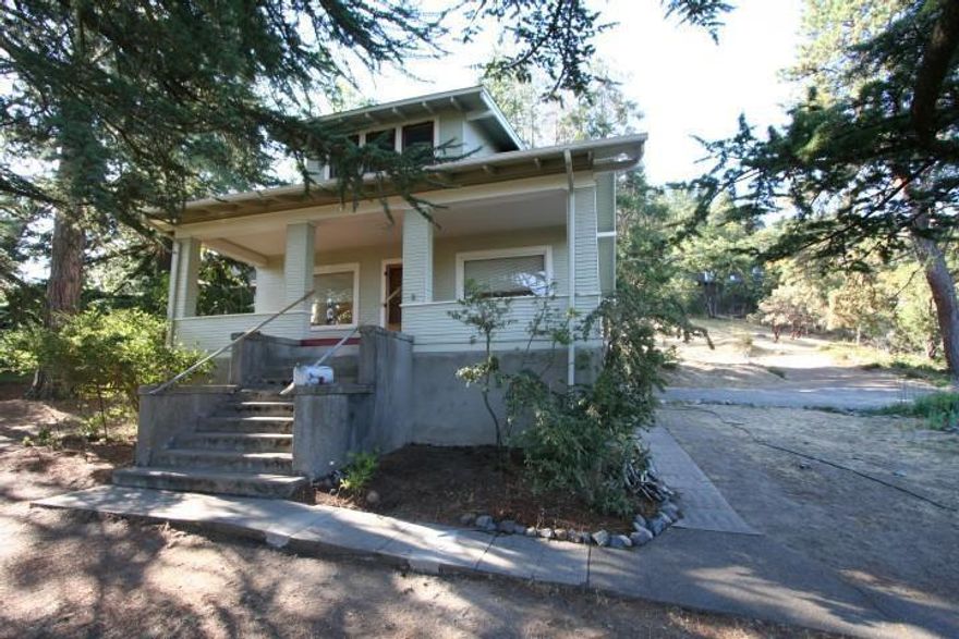 If location, location, location is what you're looking for, then look no further. This well cared for, vintage home is situated on a spacious lot is in the heart of downtown Ashland. Literally a stone's throw from the theatres, you will park your car and never need it again. Craftsman detailing throughout including beautifully wood wrapped windows and molding, some original wood flooring including fir and oak, leaded glass windows and more. Cozy, oversized covered porch with knock out views of both Grizzly Peak and the hillsides above Lithia Park. The kitchen is open and spacious, features charming built-ins, generous storage and brand new range/oven. Screen in service porch, interior laundry rooms. Lush, mature landscaping, unbelievable gardening spaces. There is also forced air natural gas heat and central air conditioning.