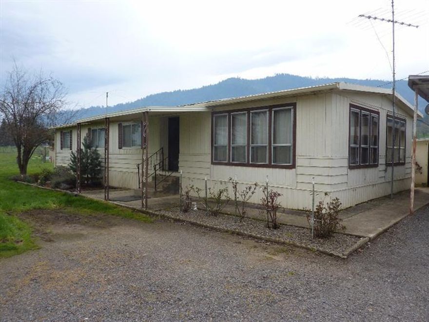 This is a highly desirable property in an area of high end homes. You could use the existing manufactured home while building your dream home or designing a new manufactured home. The Kirkwood manufactured home has 3 bedrooms and 2 baths, 1440 sq ft and built in 1973 so it is usually not financeable. Close by is a 2 car garage. The land is flat and all usable for horses, pets or building that shop you've always wanted. There is plenty of fenced pasture complete with a 3 stall barn/shelter plus tack area or 4th stall. If you have a green thumb, make use of the fenced garden area and garden shed behind the home.